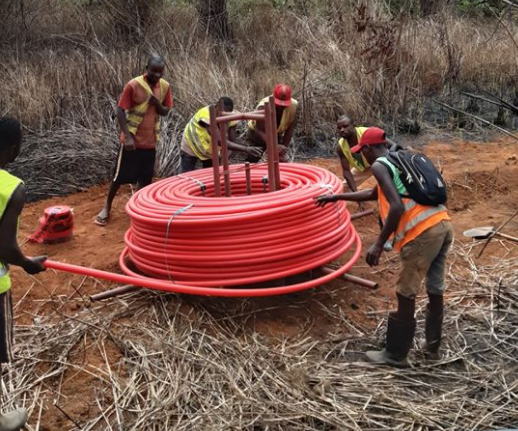 Men installing cable under the ground