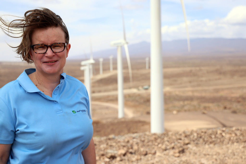 Person standing in front of the wind farm